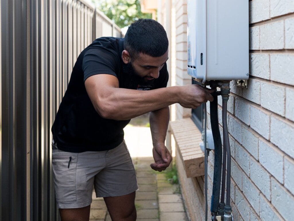 Same Day Trades plumber servicing a hot water unit